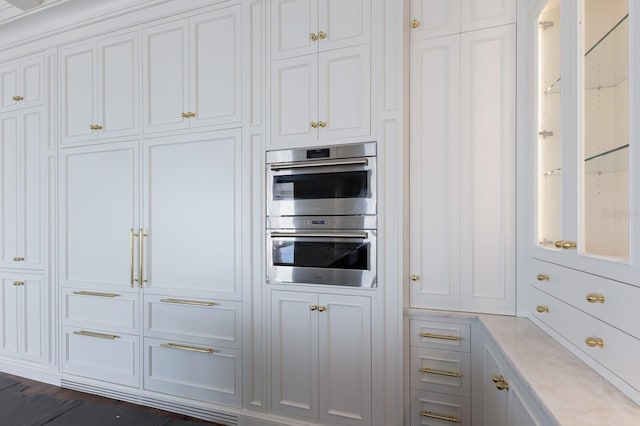 894 Hill Tide Ln, Boca Grande, FL 33921 - kitchen featuring stainless steel double oven and white cabinets