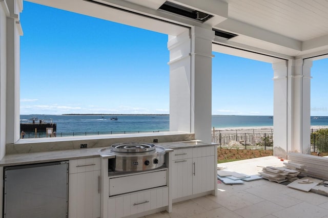 894 Hill Tide Ln, Boca Grande, FL 33921 - view of patio / terrace featuring an outdoor kitchen and a water view
