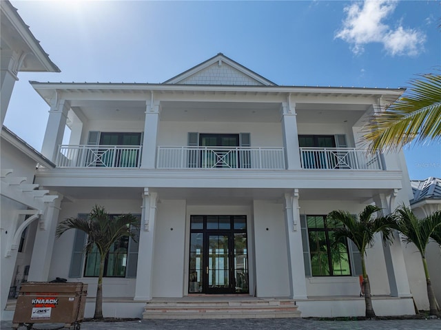 894 Hill Tide Ln, Boca Grande, FL 33921 - view of front of house featuring a balcony, covered porch, and stucco siding