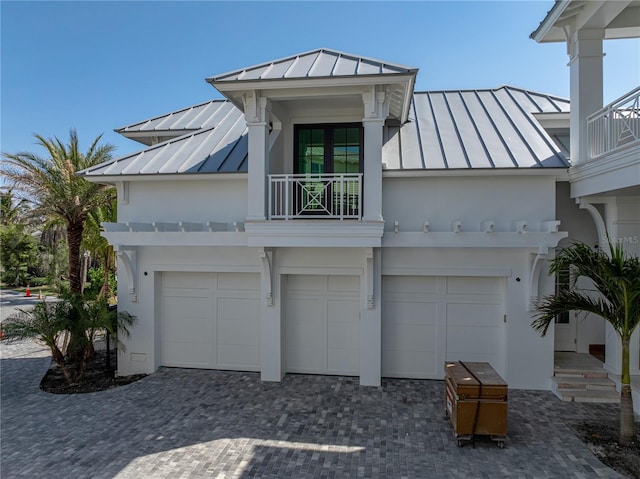 894 Hill Tide Ln, Boca Grande, FL 33921 - view of front facade featuring a standing seam roof, metal roof, a balcony, and stucco siding