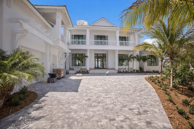 894 Hill Tide Ln, Boca Grande, FL 33921 - coastal home featuring a balcony, covered porch, and stucco siding