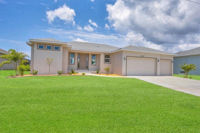 prairie-style home featuring a front lawn and a garage