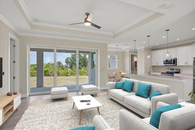 8343 Olsen St, Port Charlotte, FL 33981 - living room with sink, ornamental molding, ceiling fan, and a raised ceiling