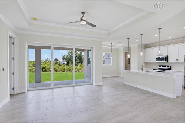 8343 Olsen St, Port Charlotte, FL 33981 - kitchen with a raised ceiling, light tile floors, pendant lighting, and appliances with stainless steel finishes