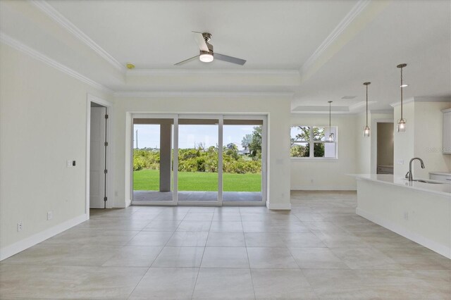 8343 Olsen St, Port Charlotte, FL 33981 - unfurnished living room with sink, ceiling fan, light tile floors, and a raised ceiling