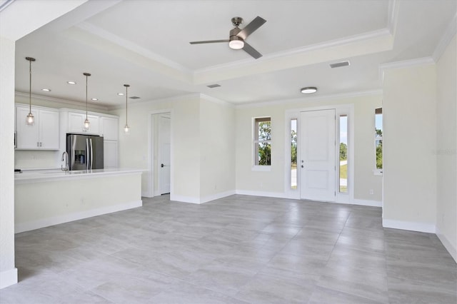 8343 Olsen St, Port Charlotte, FL 33981 - entrance foyer featuring a tray ceiling, crown molding, and light tile floors