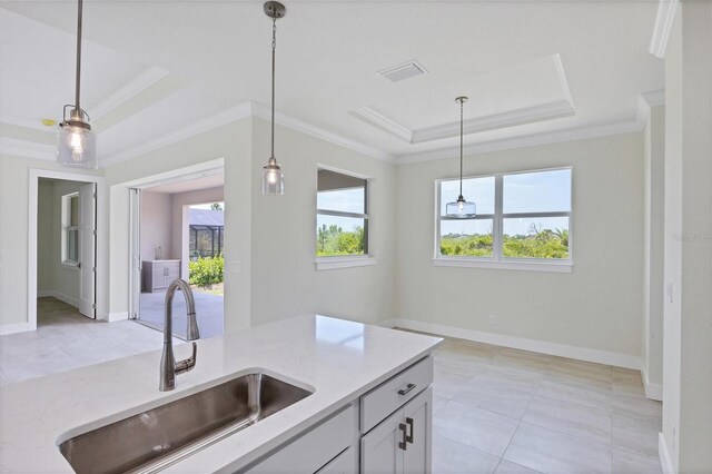 8343 Olsen St, Port Charlotte, FL 33981 - kitchen featuring plenty of natural light, sink, a tray ceiling, and pendant lighting
