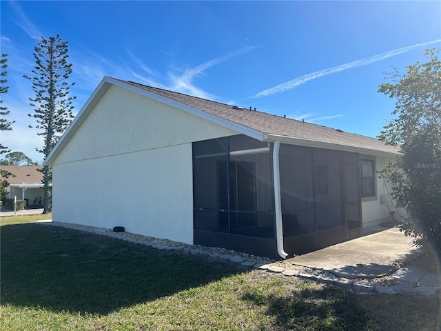 view of side of home featuring a yard and a sunroom