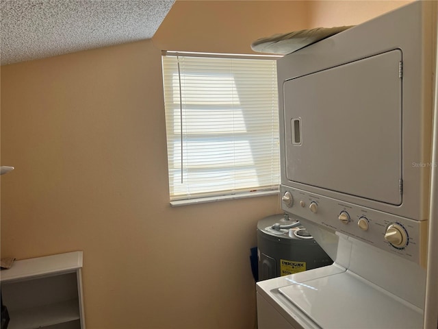 washroom with a textured ceiling and stacked washer / drying machine