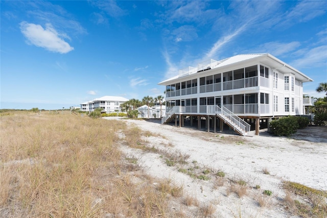 rear view of property featuring a balcony