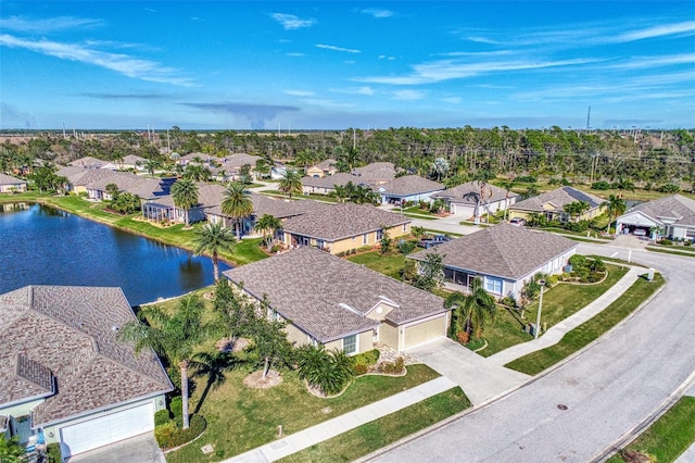 drone / aerial view featuring a residential view and a water view