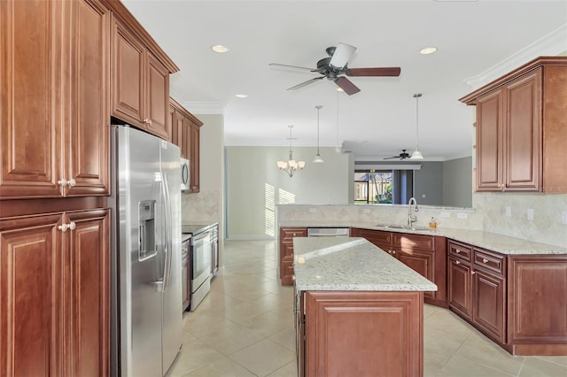 kitchen with a peninsula, a sink, ornamental molding, stainless steel appliances, and backsplash