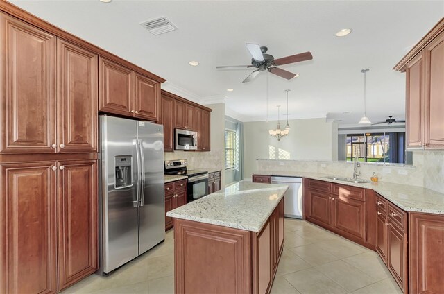 kitchen with a peninsula, visible vents, a wealth of natural light, and stainless steel appliances