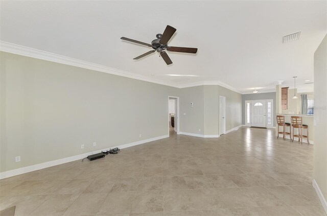 unfurnished living room featuring a ceiling fan, crown molding, baseboards, and visible vents