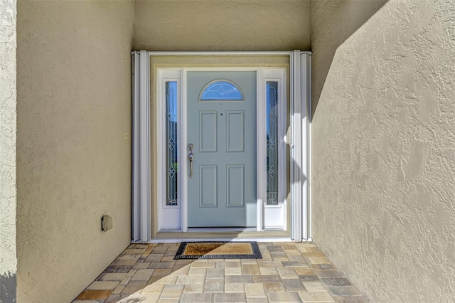 doorway to property with stucco siding