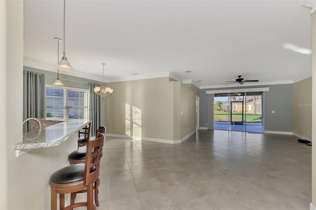 interior space featuring light tile patterned floors, ceiling fan with notable chandelier, baseboards, and ornamental molding