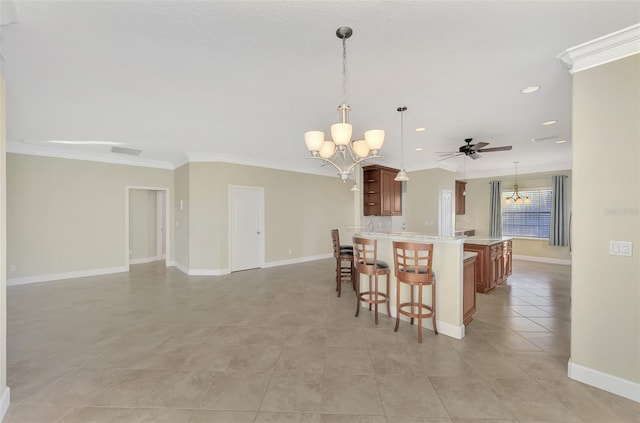 kitchen featuring a breakfast bar area, visible vents, ornamental molding, and light countertops