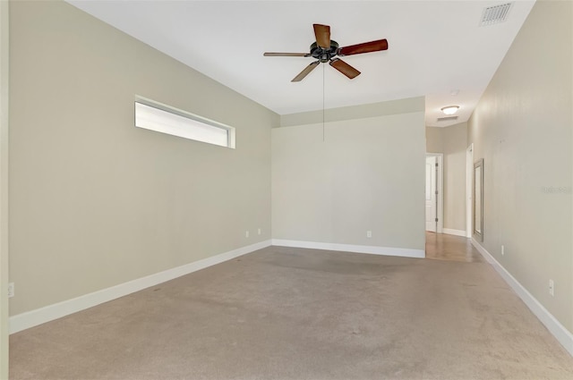 empty room with a ceiling fan, baseboards, and visible vents