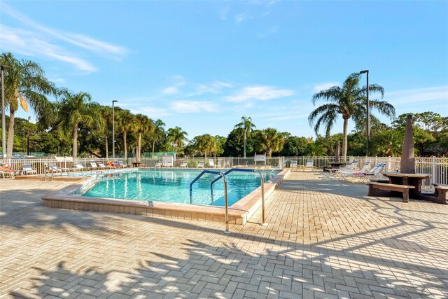 pool featuring a patio and fence