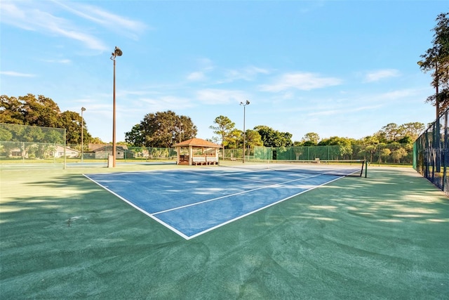 view of sport court with a gazebo and fence