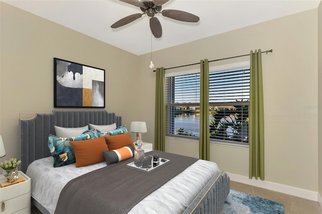 carpeted bedroom with baseboards and a ceiling fan