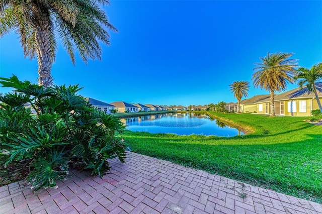 view of patio / terrace with a residential view and a water view