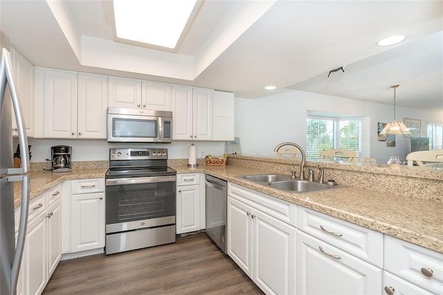 kitchen featuring white cabinets, appliances with stainless steel finishes, dark hardwood / wood-style floors, and sink