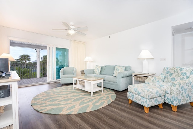 living room with ceiling fan and dark wood-type flooring