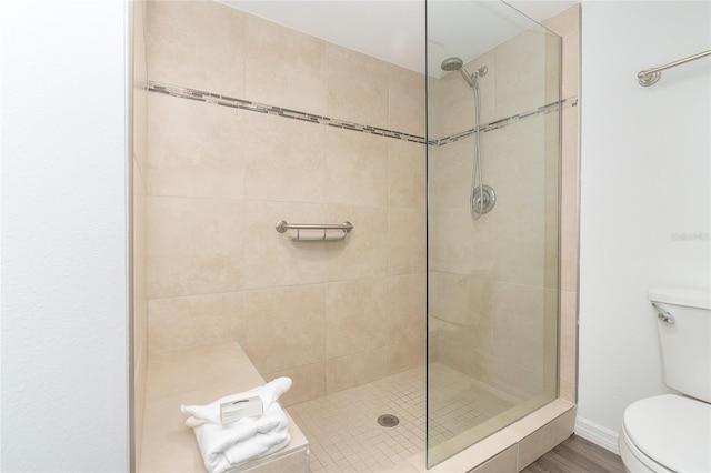 bathroom featuring toilet and tiled shower