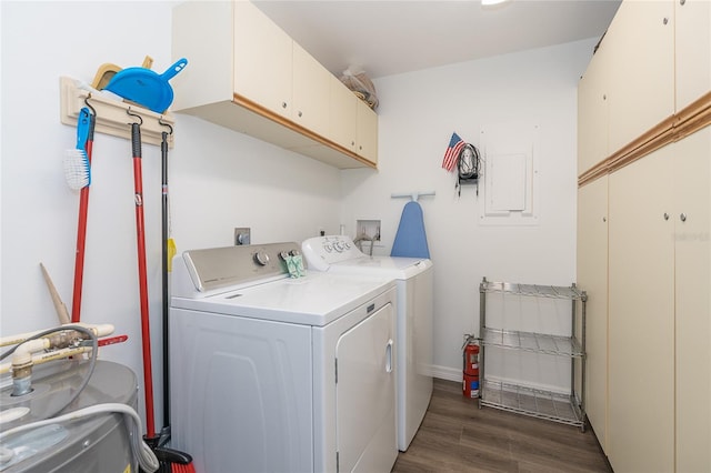 washroom featuring washer hookup, washing machine and clothes dryer, dark wood-type flooring, and cabinets