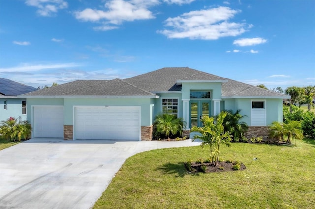 view of front of property with french doors, a front lawn, and a garage