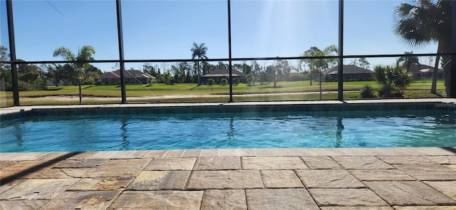 view of pool featuring glass enclosure