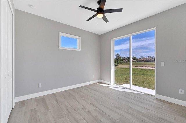 empty room featuring ceiling fan and light wood-type flooring