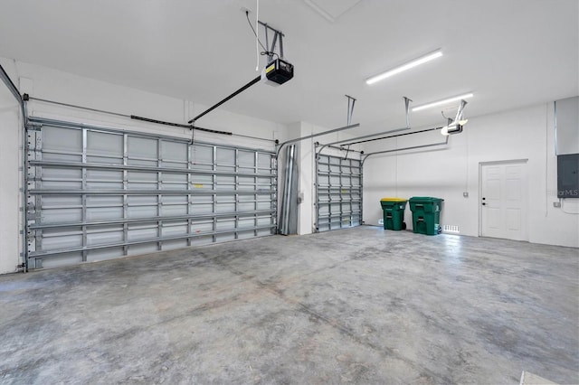 garage featuring electric panel and a garage door opener