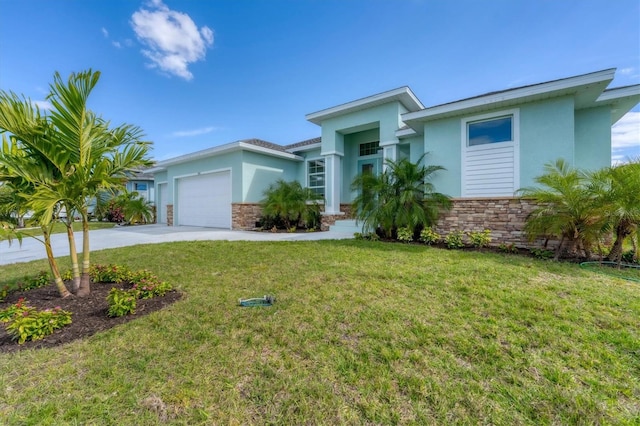 view of front of home with a front yard and a garage