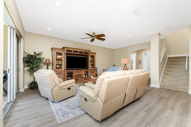 living room featuring ceiling fan and light wood-type flooring