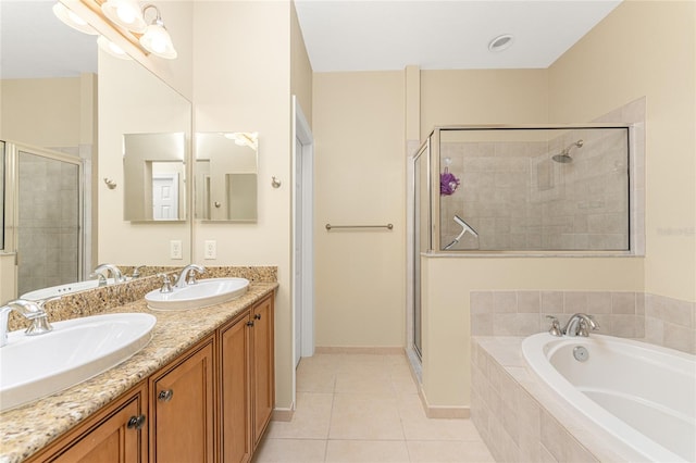 bathroom featuring separate shower and tub, tile floors, and dual vanity