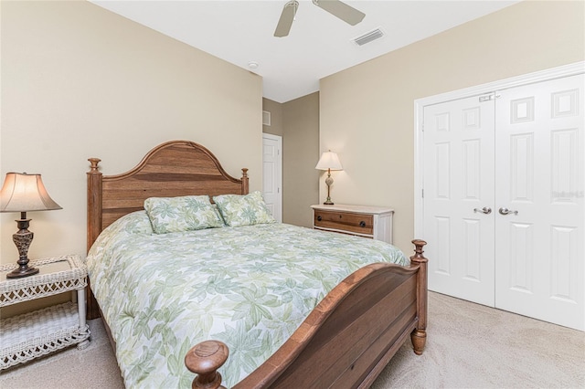 bedroom featuring a closet, light carpet, and ceiling fan