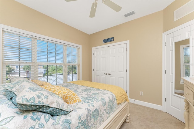 carpeted bedroom with a closet and ceiling fan