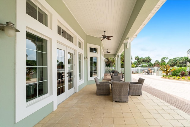 view of terrace with ceiling fan and french doors