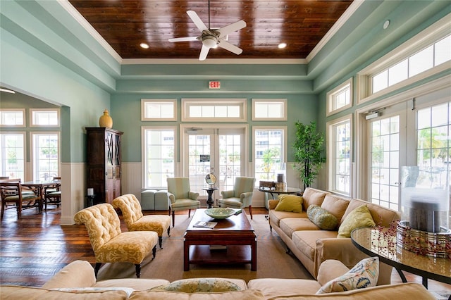 living room featuring crown molding, dark hardwood / wood-style flooring, wooden ceiling, and ceiling fan