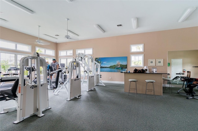 exercise room with ceiling fan