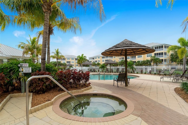 view of swimming pool with a patio and a hot tub