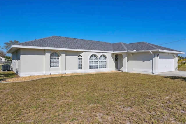 ranch-style house featuring a front yard and a garage