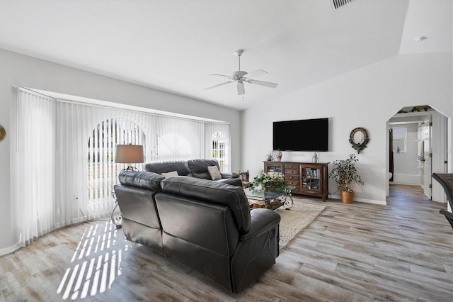 living room featuring plenty of natural light, light hardwood / wood-style floors, ceiling fan, and lofted ceiling