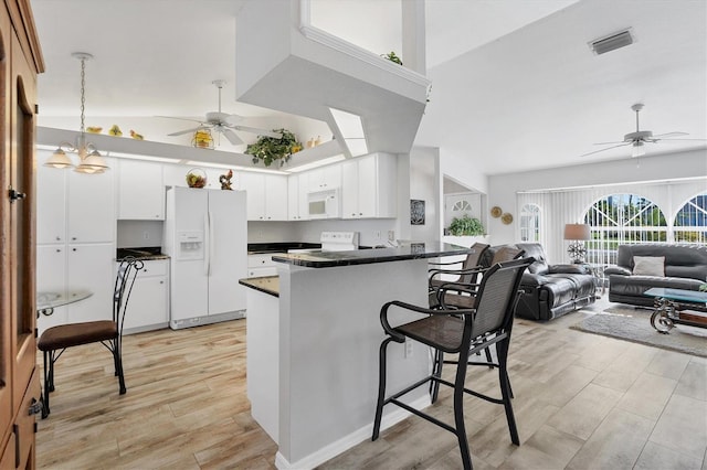 kitchen featuring kitchen peninsula, ceiling fan with notable chandelier, white appliances, white cabinetry, and light wood-type flooring