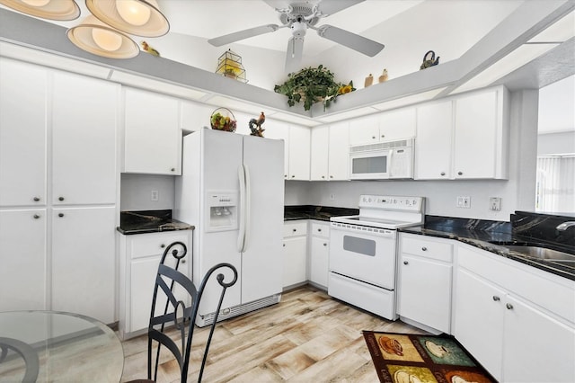 kitchen featuring white appliances, white cabinetry, ceiling fan, and light wood-type flooring