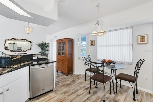 kitchen featuring white cabinets, light hardwood / wood-style flooring, dishwasher, and an inviting chandelier