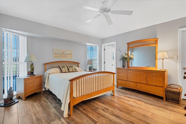 bedroom with hardwood / wood-style floors and ceiling fan