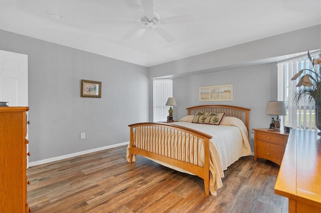 bedroom with ceiling fan and dark wood-type flooring